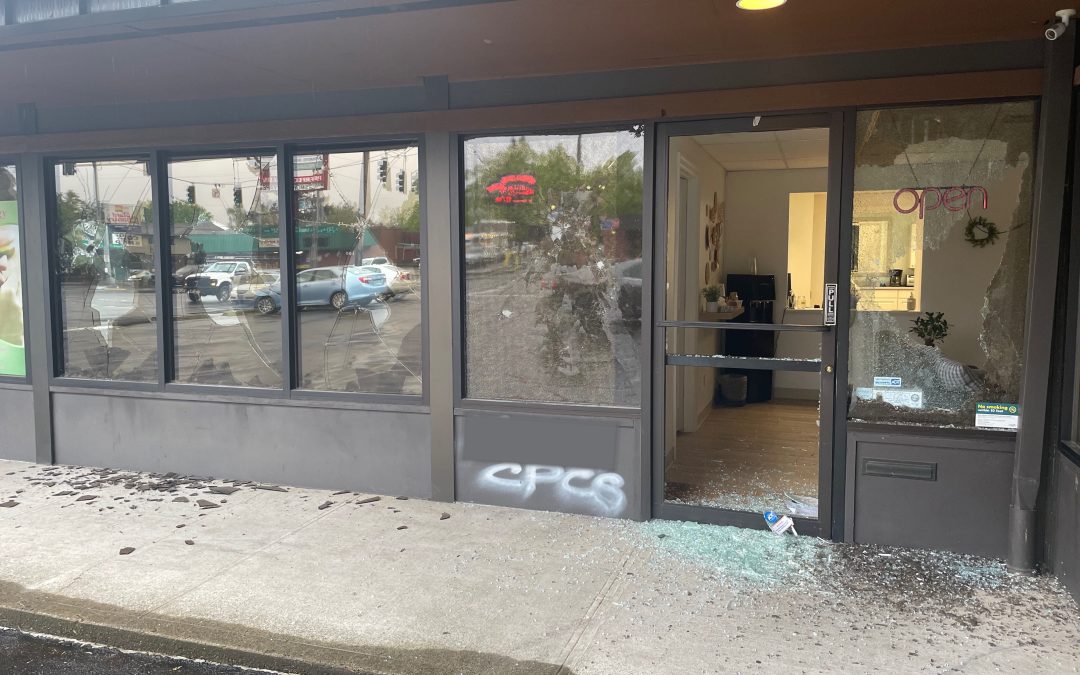 Photo of Southeast Center's shattered glass windows and door