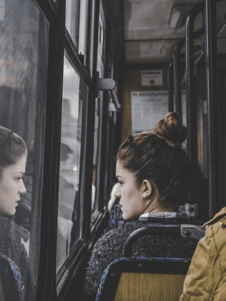 Woman staring out window on train